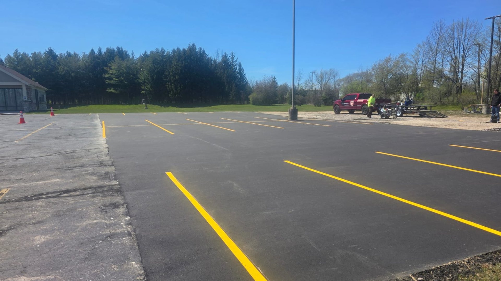 A freshly sealed and striped commercial parking lot maintained by Draki Enterprises in Manitowoc, WI
