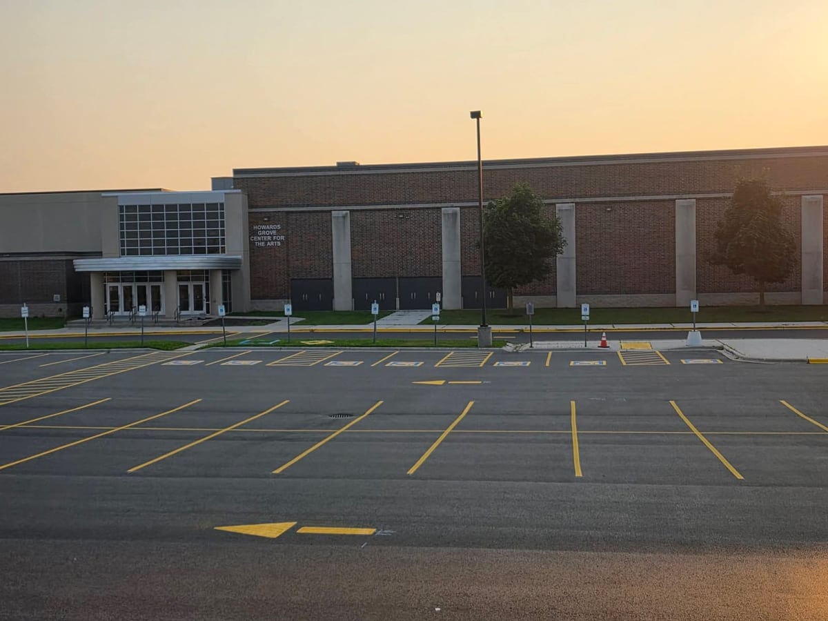 the Howards Grove High School parking lot, sealcoated and freshly striped by Draki Enterprises in Wisconsin