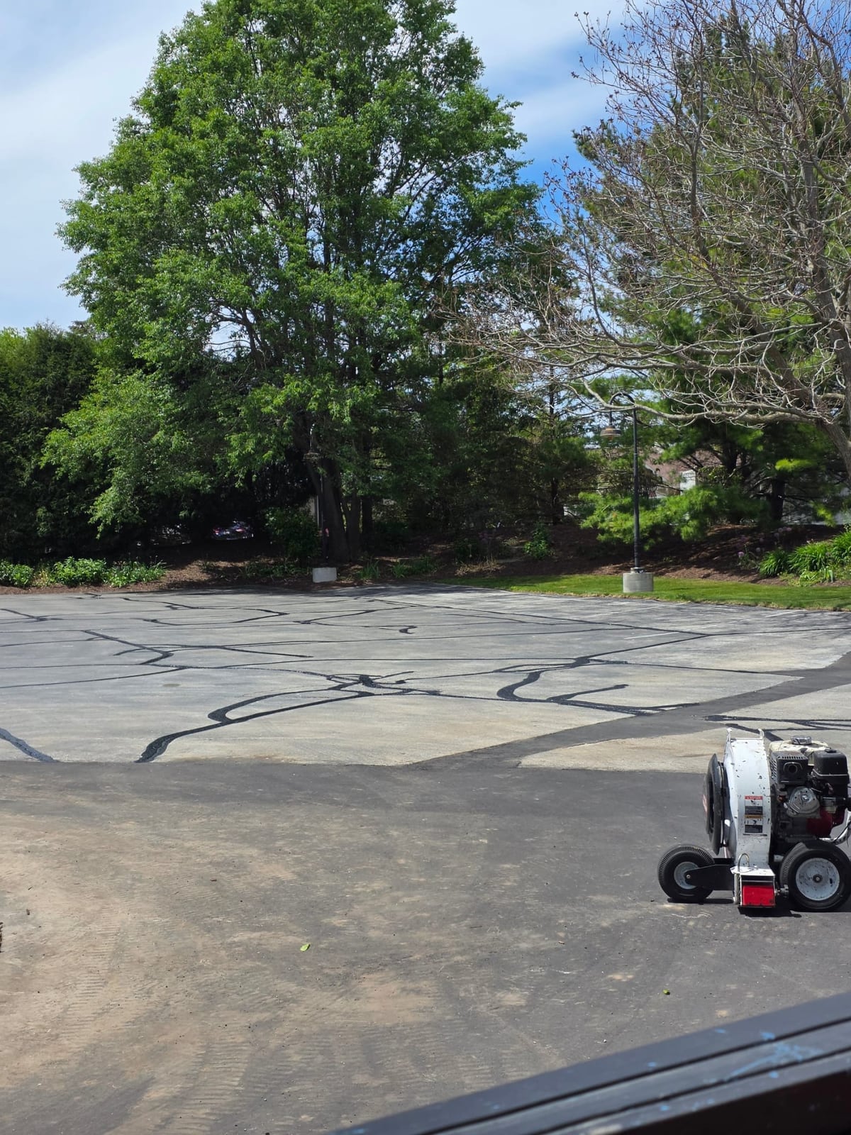 a long sealed asphalt drive with cracks filled and sealed by Draki Enterprises in Wisconsin