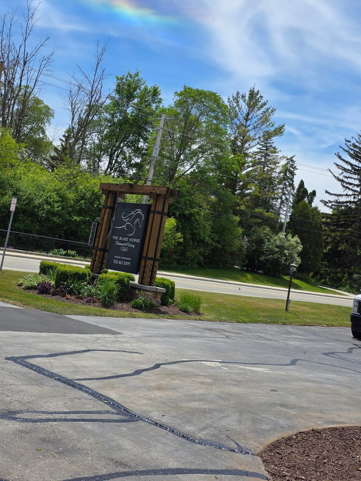 a commercial property with a monument sign and a freshly sealed, striped lot by Draki Enterprises in Wisconsin