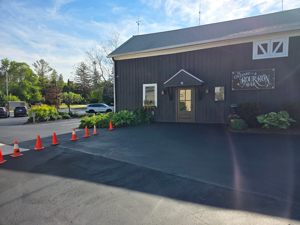 an event venue with a sealed lot and a long row of cones set out by Draki Enterprises in Wisconsin