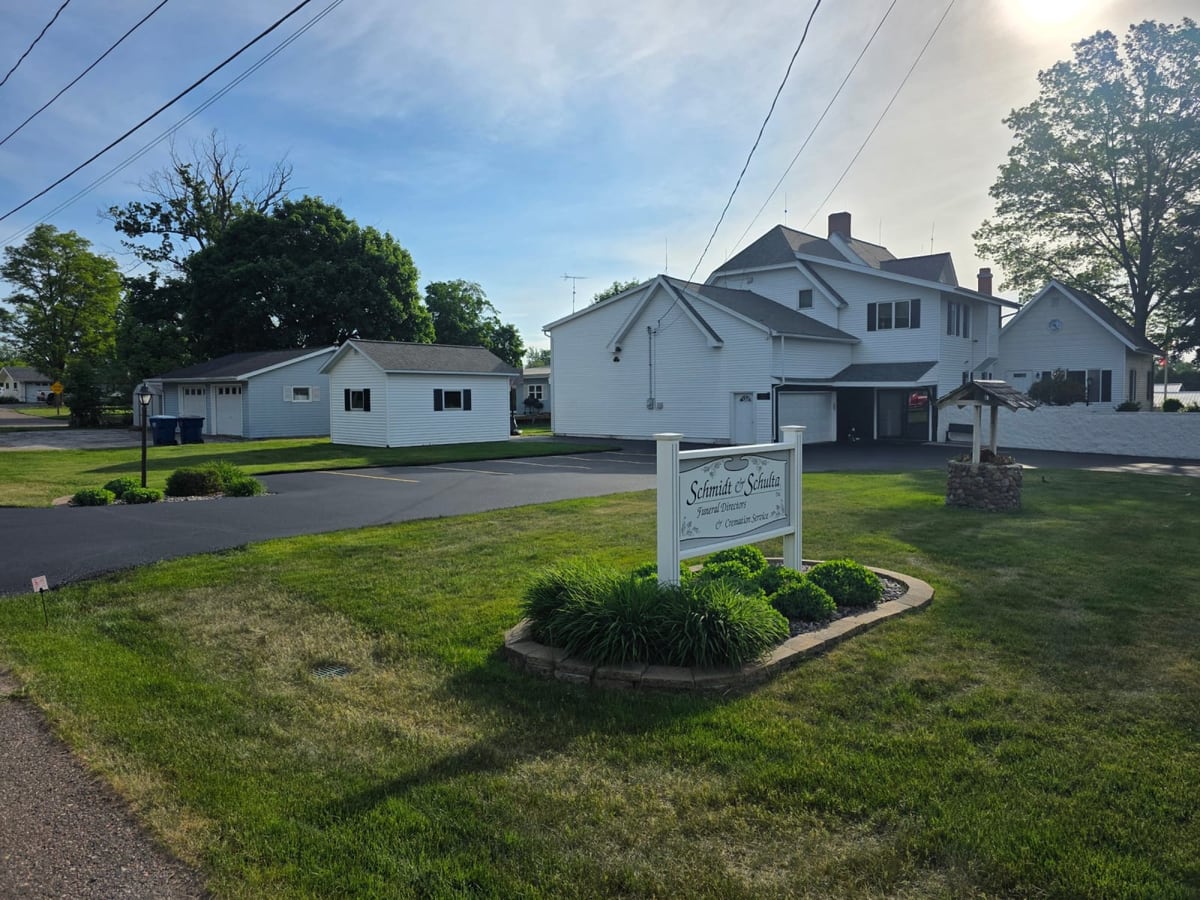 a residential property with a sign and a freshly sealed drive by Draki Enterprises in Wisconsin