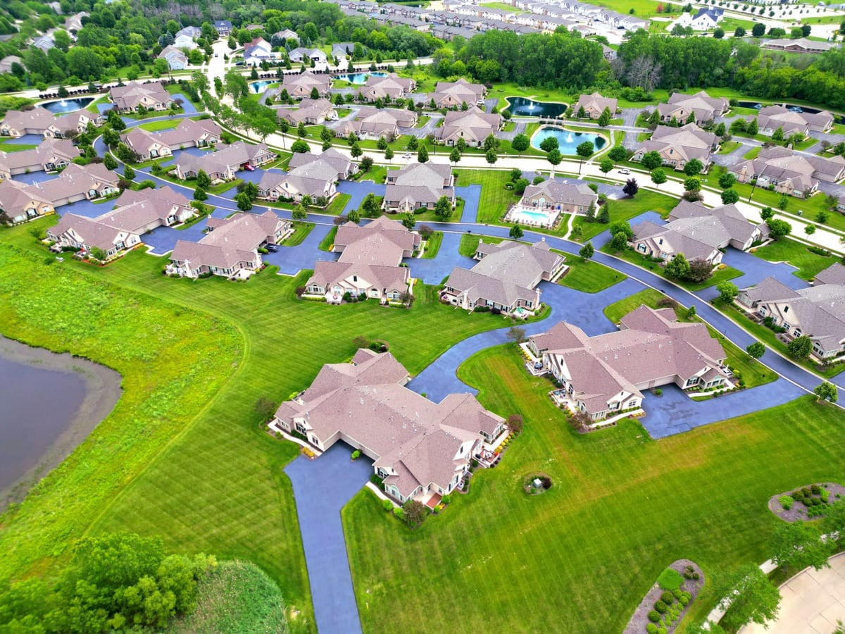 a drone view of a residential community with newly sealed streets by Draki Enterprises in Wisconsin