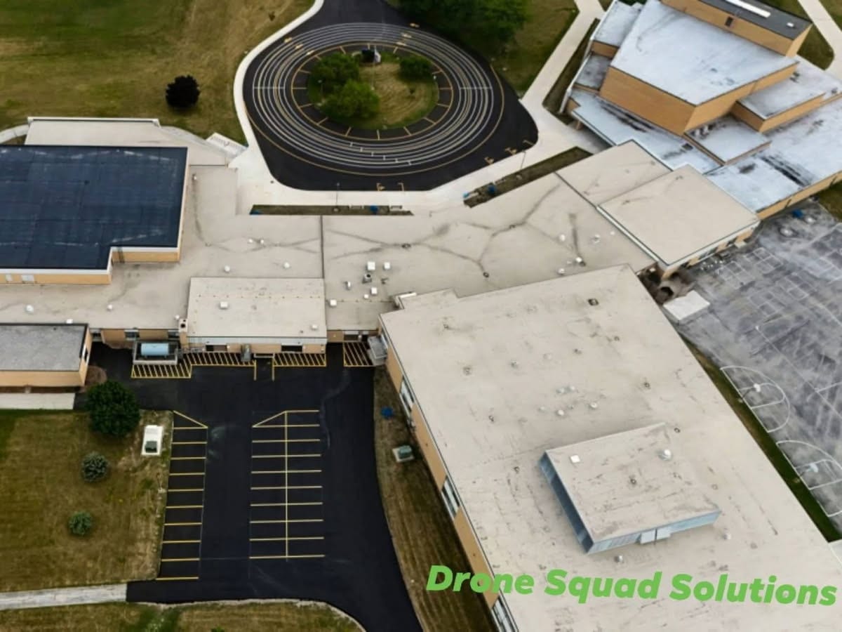 drone aerial of the Howards Grove High School campus with freshly sealed and striped lots by Draki Enterprises in Wisconsin